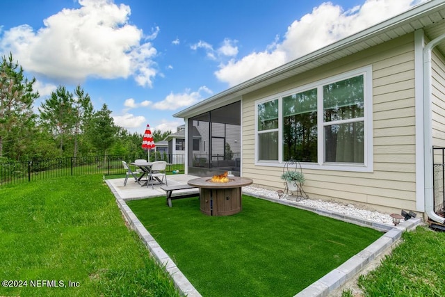 view of yard featuring an outdoor fire pit and a patio