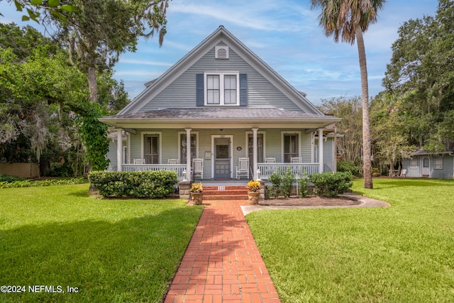 farmhouse-style home with a front yard and a porch