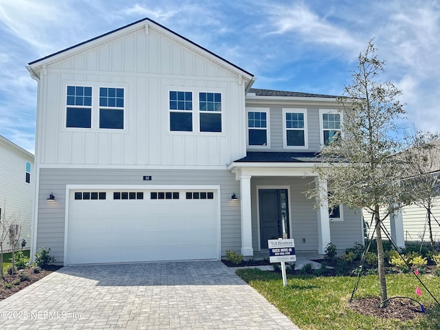 view of front of house with decorative driveway, a garage, and board and batten siding