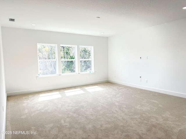 unfurnished room featuring recessed lighting, carpet, visible vents, and baseboards