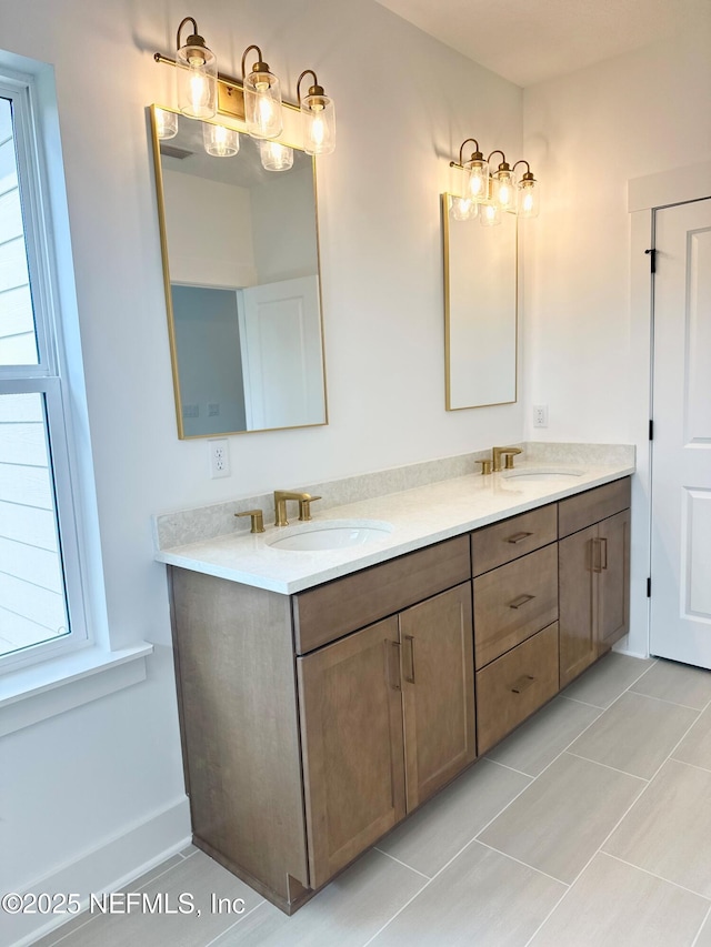 full bathroom with a sink, double vanity, and tile patterned floors