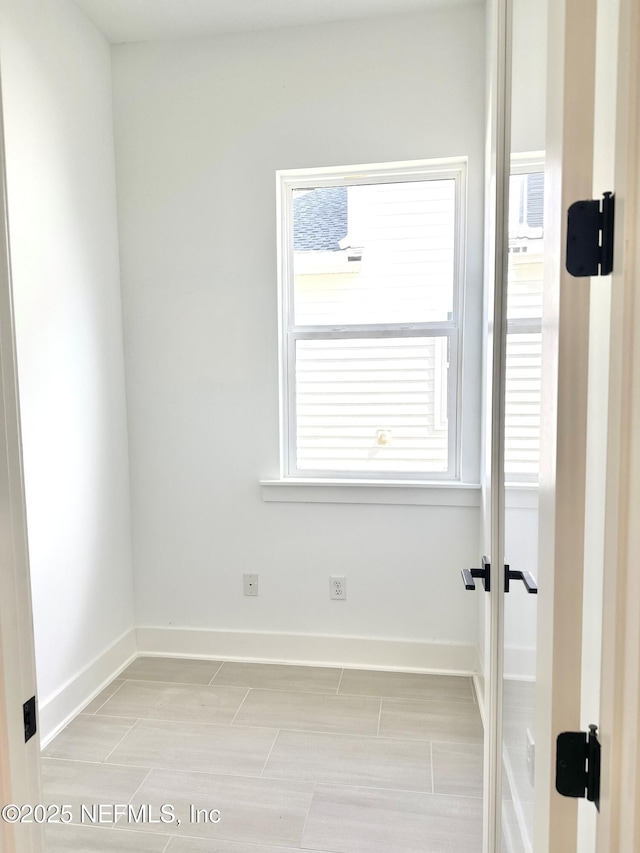 unfurnished room featuring baseboards