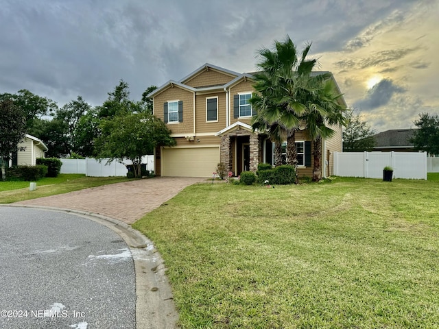 view of front facade featuring a garage and a lawn