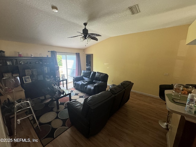 living room featuring hardwood / wood-style floors, a textured ceiling, vaulted ceiling, and ceiling fan