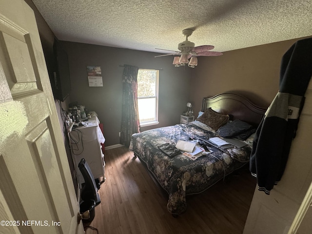 7071 Luke St, Jacksonville, FL 32210 - bedroom featuring a ceiling fan, a textured ceiling, baseboards, and wood finished floors