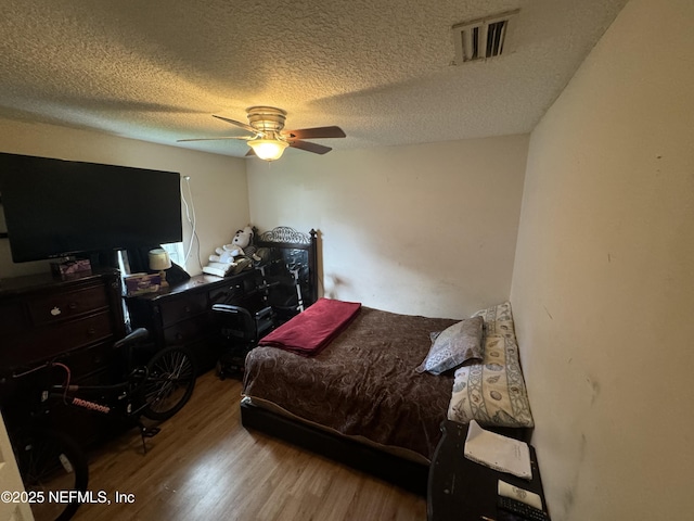 7071 Luke St, Jacksonville, FL 32210 - bedroom with visible vents, wood finished floors, ceiling fan, and a textured ceiling