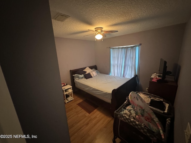 7071 Luke St, Jacksonville, FL 32210 - bedroom with visible vents, wood finished floors, ceiling fan, and a textured ceiling