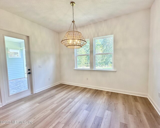 63 Oakmoss Dr, Saint Johns, FL 32259 - unfurnished dining area featuring baseboards, wood finished floors, and a chandelier