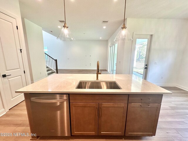 63 Oakmoss Dr, Saint Johns, FL 32259 - kitchen with a kitchen island with sink, a sink, light wood-style flooring, and dishwasher