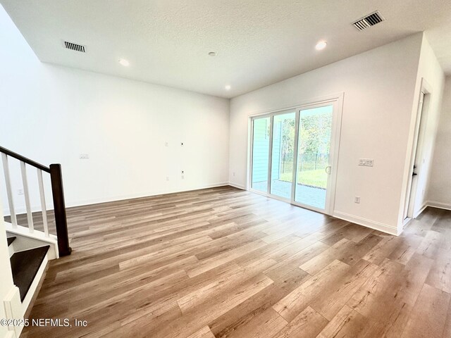63 Oakmoss Dr, Saint Johns, FL 32259 - unfurnished living room featuring visible vents, recessed lighting, stairway, and light wood-type flooring