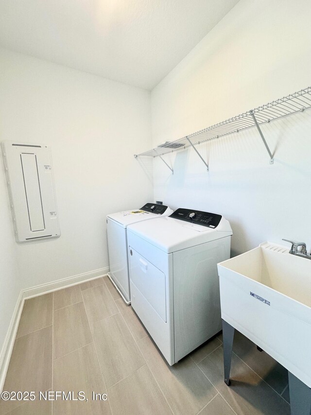 63 Oakmoss Dr, Saint Johns, FL 32259 - laundry room with a sink, baseboards, laundry area, and washing machine and dryer