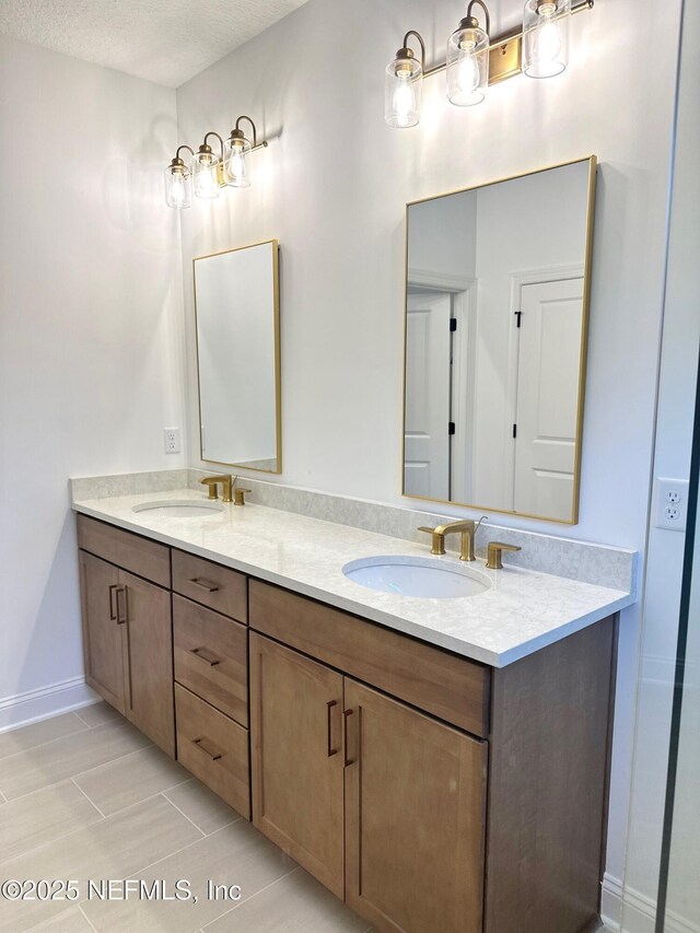 63 Oakmoss Dr, Saint Johns, FL 32259 - bathroom featuring a sink, a textured ceiling, tile patterned flooring, and double vanity