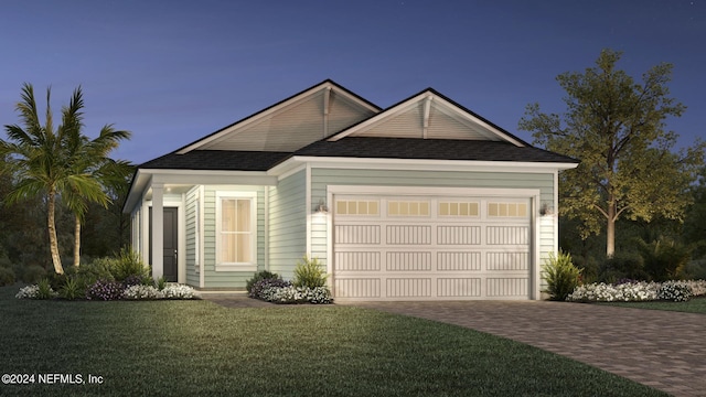 view of front of home with a front yard and a garage