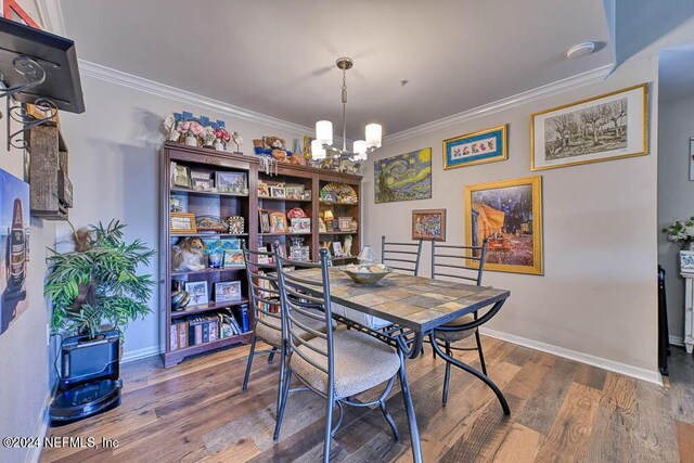 dining area featuring hardwood / wood-style flooring, a chandelier, and crown molding