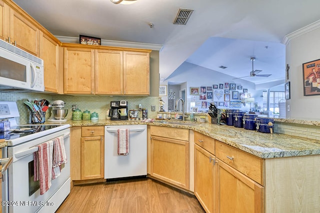 kitchen featuring white appliances, sink, light wood-type flooring, ceiling fan, and kitchen peninsula