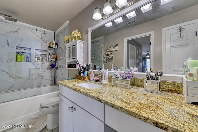 full bathroom with tiled shower / bath combo, toilet, and vanity