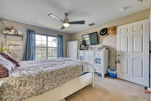 bedroom with ceiling fan and light colored carpet