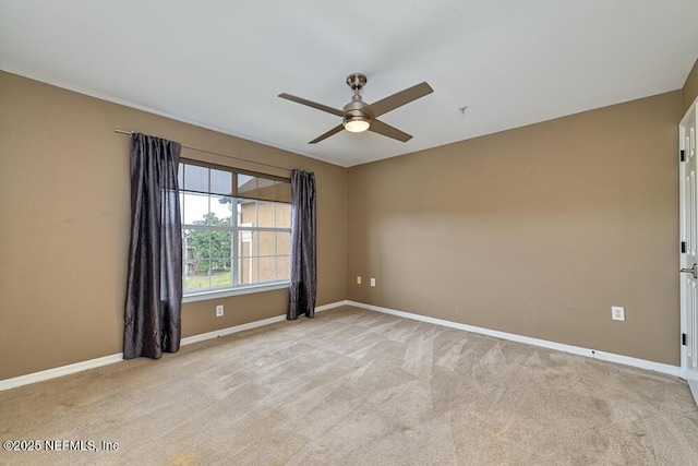 unfurnished room with ceiling fan and light colored carpet