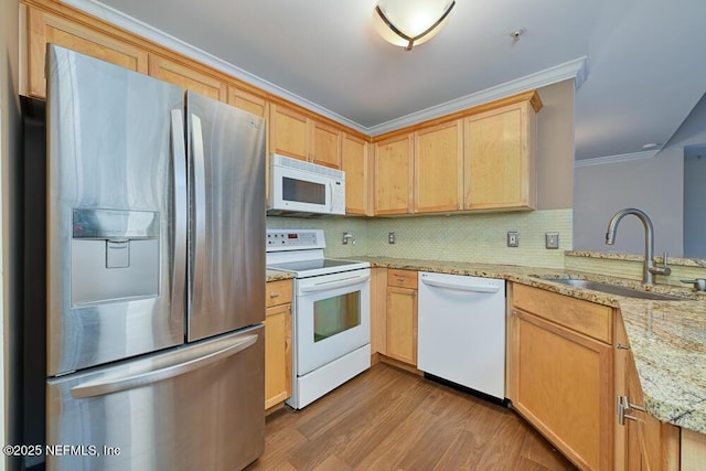 kitchen with light brown cabinetry, white appliances, light stone countertops, crown molding, and sink