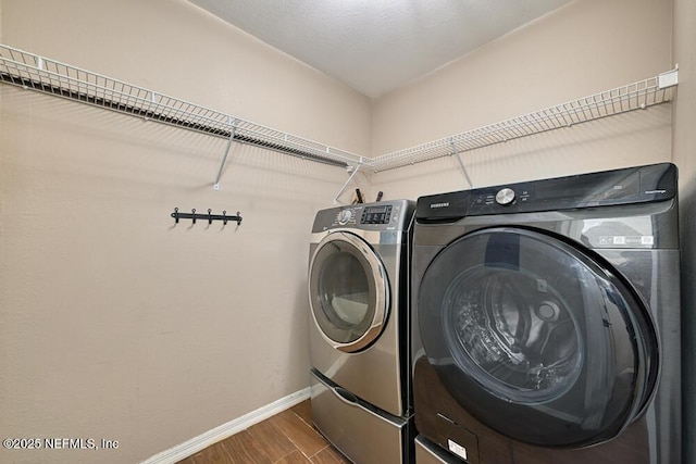 laundry room featuring hardwood / wood-style floors and washing machine and clothes dryer