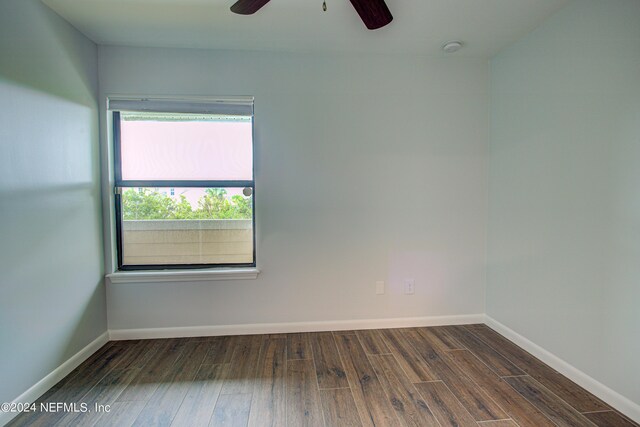 unfurnished room featuring dark hardwood / wood-style flooring and ceiling fan