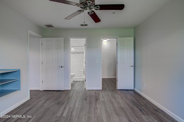 unfurnished bedroom featuring wood-type flooring, ensuite bath, and ceiling fan