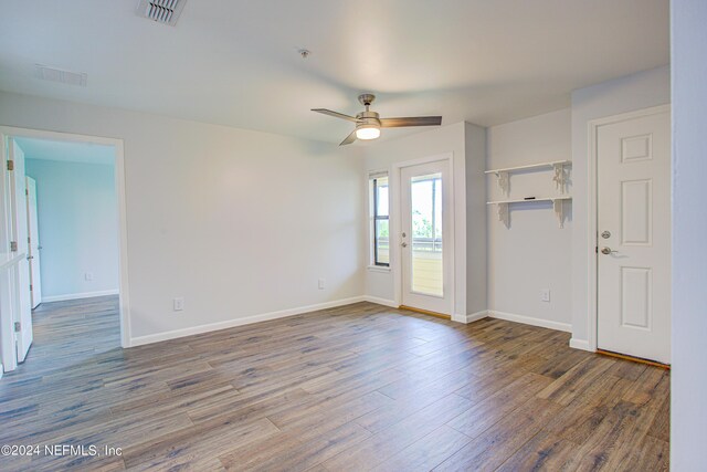 spare room with ceiling fan and dark hardwood / wood-style floors