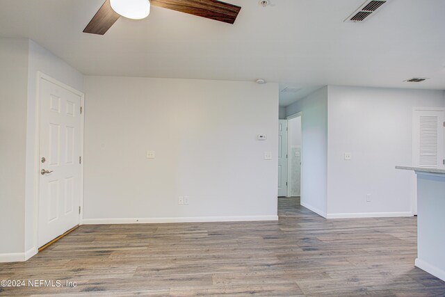 spare room featuring ceiling fan and light hardwood / wood-style flooring