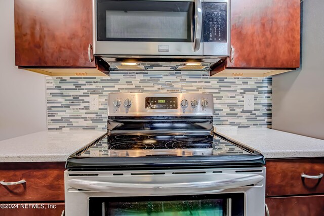 kitchen with stainless steel appliances and tasteful backsplash