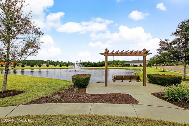 surrounding community with a lawn and a water view