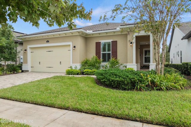 view of front of property with a front lawn and a garage