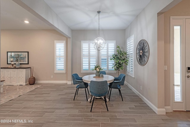 dining area featuring a chandelier and light hardwood / wood-style flooring