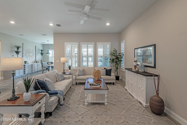 living room featuring ceiling fan and light hardwood / wood-style flooring