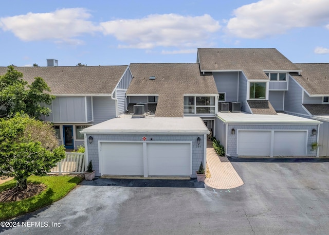 view of front of property featuring central AC and a garage