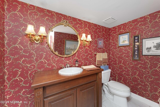 bathroom with tile patterned flooring, vanity, and toilet