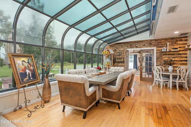 sunroom with a healthy amount of sunlight and lofted ceiling