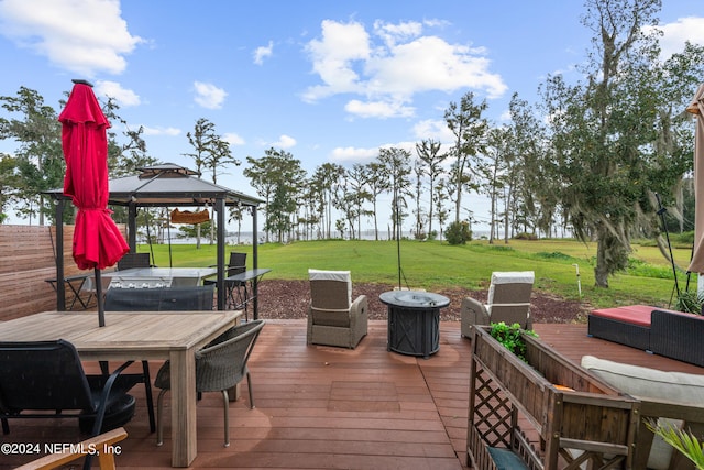 wooden deck with a gazebo, a yard, and a water view