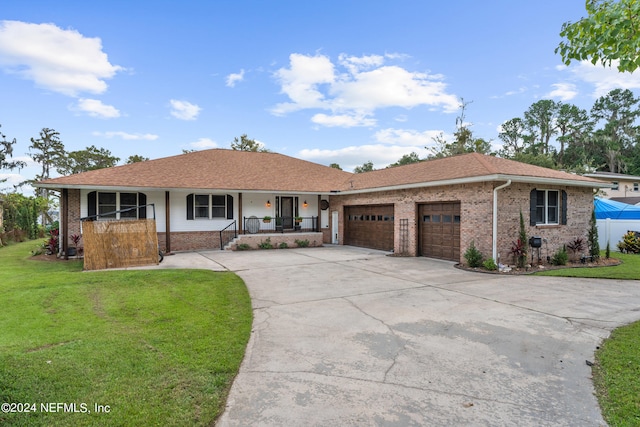 ranch-style house with a garage, covered porch, and a front lawn