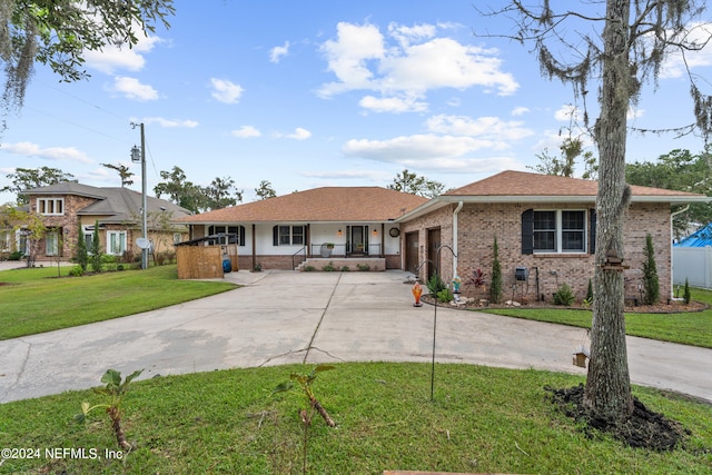 ranch-style house with a porch and a front lawn