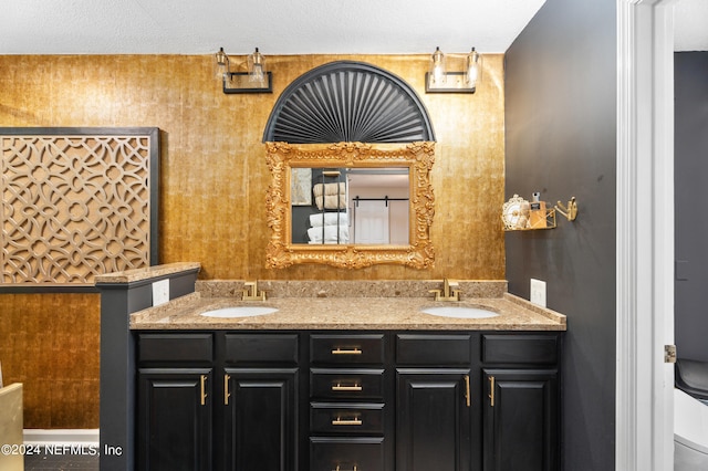 bathroom featuring a textured ceiling, toilet, and vanity