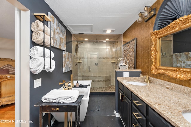 bathroom featuring a textured ceiling, walk in shower, and vanity