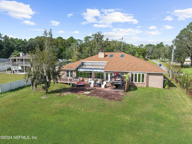 back of property with a patio area and a yard