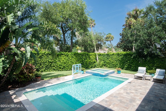 view of pool with a patio and an in ground hot tub