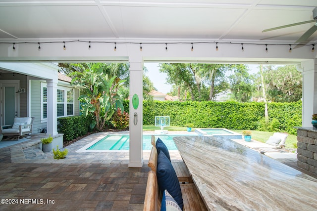 view of swimming pool with ceiling fan