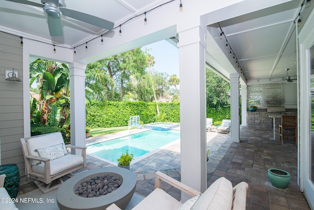 view of swimming pool featuring an outdoor fire pit, ceiling fan, and a patio