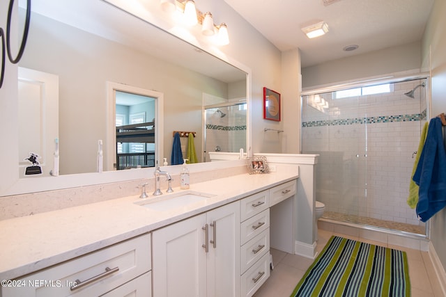 bathroom featuring tile patterned floors, walk in shower, toilet, and vanity