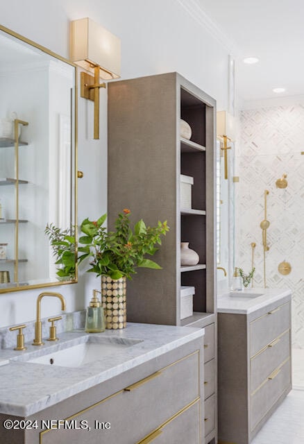 bathroom with ornamental molding and vanity