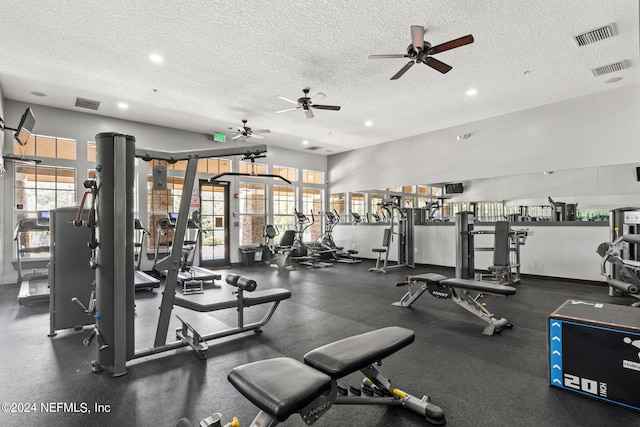 exercise room with ceiling fan and a textured ceiling