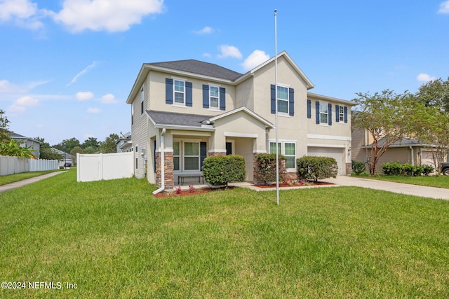 view of front of home featuring a front yard and a garage