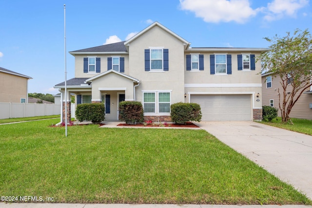 view of front of house featuring a front yard and a garage